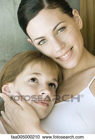 Preteen girl resting head on young woman's chest View Large Photo Image Stock Image - Preteen girl resting head on young woman's chest. Fotosearch