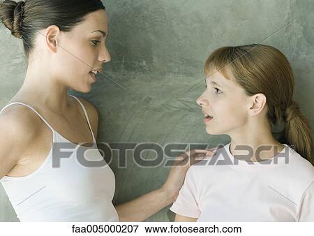 Stock Photo - Preteen girl talking to older sister. Fotosearch