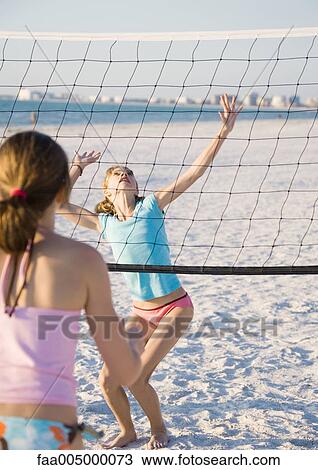 Preteen girls playing beach volleyball View Large Photo Image Stock Image - Preteen girls playing beach volleyball. Fotosearch