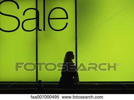 Sale sign in shop window and silhouette of passer-by View Large Photo Image Stock Photography - Sale sign in shop window and silhouette of passer-by. Fotosearch