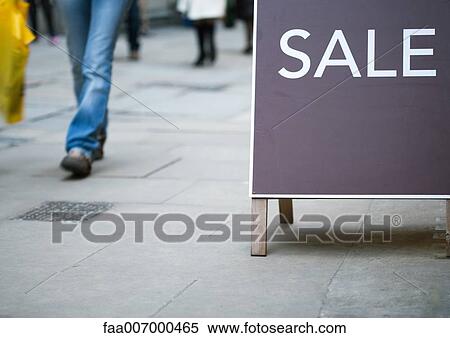 Sale sign, shopper walking by View Large Photo Image Stock Photography - Sale sign, shopper walking by. Fotosearch