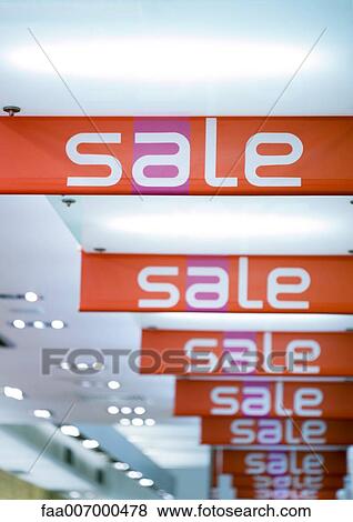 Stock Photo - Sale signs hanging from ceiling. Fotosearch