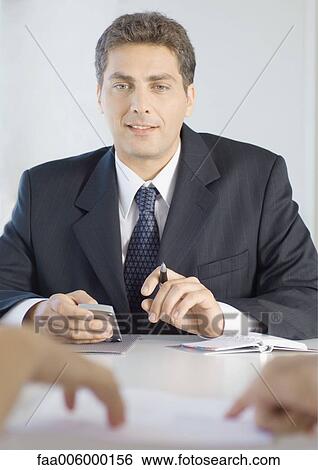 Salesman holding calculator View Large Photo Image Stock Photograph - Salesman holding calculator. Fotosearch