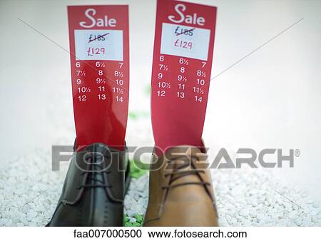 Shoes holding tag with sale price and sizes View Large Photo Image Stock Image - Shoes holding tag with sale price and sizes. Fotosearch
