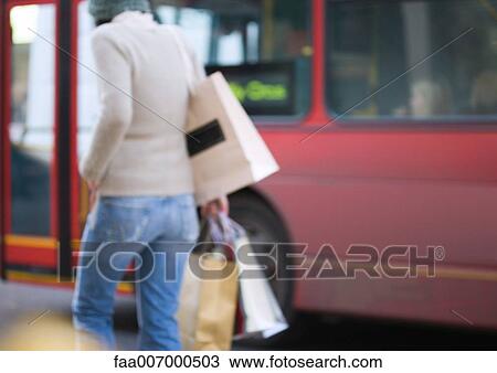 Stock Image - Shopper with shopping bags. Fotosearch