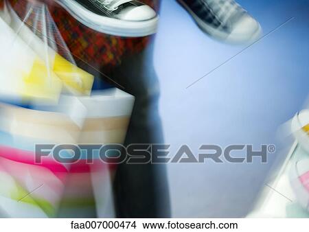 Shopping bags and canvas shoes, blurred, partial view View Large Photo Image Picture - Shopping bags and canvas shoes, blurred, partial view. Fotosearch