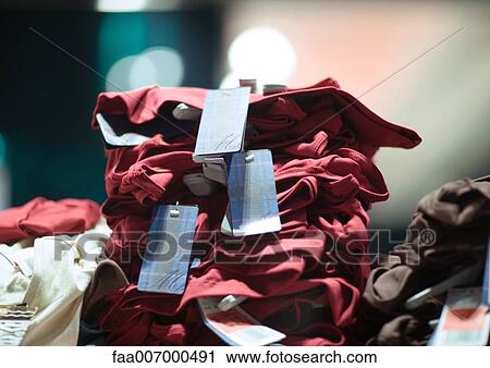 Stack of clothing in shop View Large Photo Image Stock Image - Stack of clothing in shop. Fotosearch