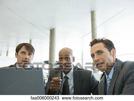 Three businessmen talking in airport View Large Photo Image Stock Image - Three businessmen talking in airport. Fotosearch