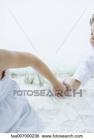 Two children holding hands and running, close-up of arms View Large Photo Image Stock Photograph - Two children holding hands and running, close-up of arms. Fotosearch