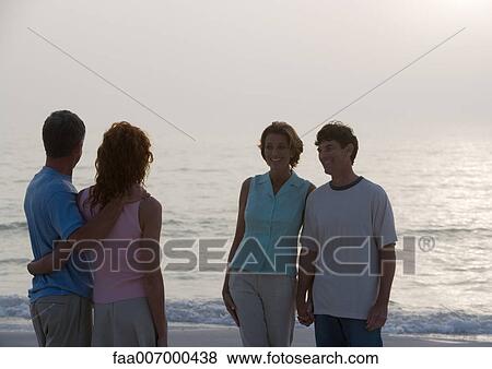 Two mature couples on beach at twilight View Large Photo Image Stock Photo - Two mature couples on beach at twilight. Fotosearch