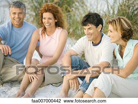 Two mature couples sitting on beach View Large Photo Image Stock Image - Two mature couples sitting on beach. Fotosearch