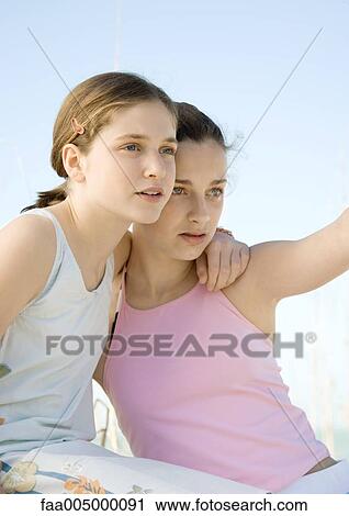 Two preteen girls, looking into the distance View Large Photo Image Stock Image - Two preteen girls, looking into the distance. Fotosearch