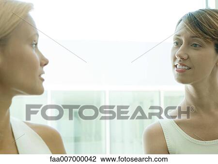 Two women speaking to each other View Large Photo Image Stock Image - Two women speaking to each other. Fotosearch