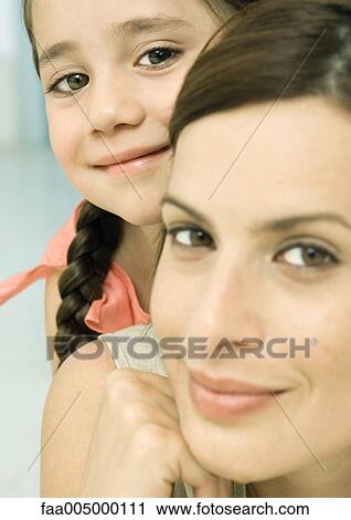 Stock Image - Woman and daughter, portrait. Fotosearch