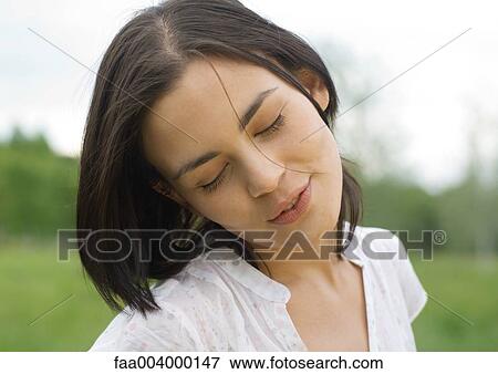 Stock Photo - Woman closing eyes and tilting head. Fotosearch