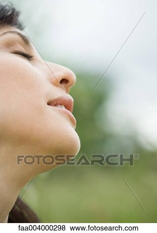 Woman closing eyes and tilting head back, close-up, side view View Large Photo Image Stock Photo - Woman closing eyes and tilting head back, close-up, side view. Fotosearch
