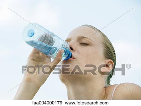 Stock Photo - Woman drinking bottled water. Fotosearch