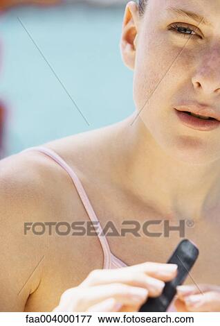 Stock Photo - Woman filing nails in sun. Fotosearch