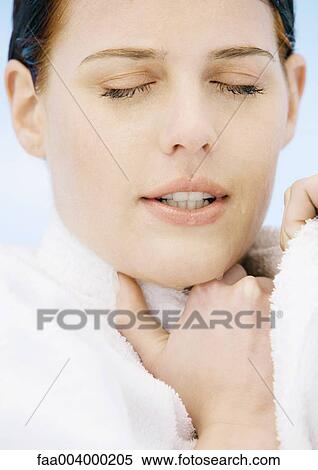Woman holding collar of bathrobe and closing eyes View Large Photo Image Stock Photography - Woman holding collar of bathrobe and closing eyes. Fotosearch