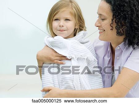 Woman holding daughter wrapped in a towel View Large Photo Image Stock Photography - Woman holding daughter wrapped in a towel. Fotosearch