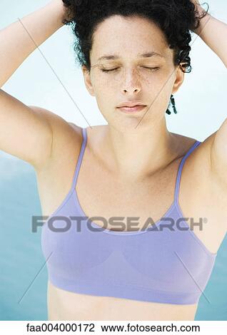 Woman holding hair back and closing eyes View Large Photo Image Stock Image - Woman holding hair back and closing eyes. Fotosearch