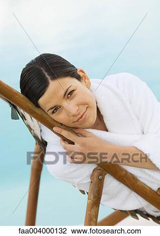 Woman in bathrobe reclining in lounge chair View Large Photo Image Stock Image - Woman in bathrobe reclining in lounge chair. Fotosearch