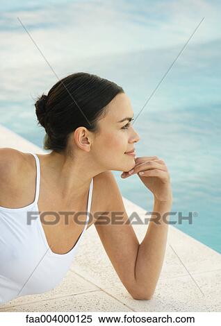 Woman leaning on elbow near edge of pool View Large Photo Image Stock Photography - Woman leaning on elbow near edge of pool. Fotosearch
