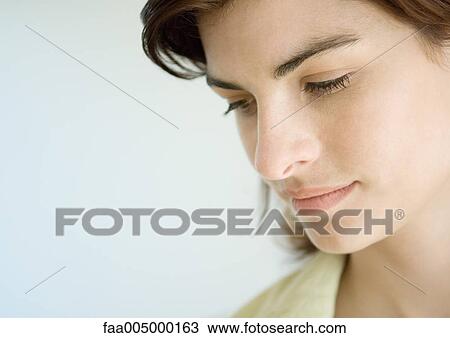 Woman looking down, close-up View Large Photo Image Stock Image - Woman looking down, close-up. Fotosearch