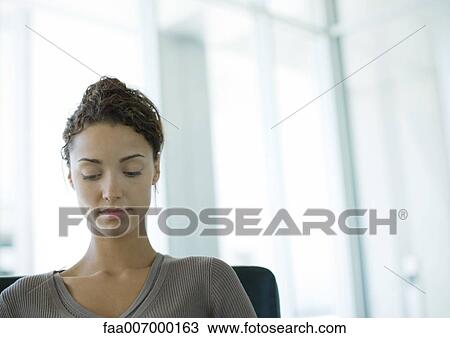 Stock Image - Woman looking down. Fotosearch