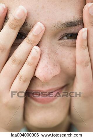 Woman looking through fingers, extreme close-up View Large Photo Image Stock Photograph - Woman looking through fingers, extreme close-up. Fotosearch