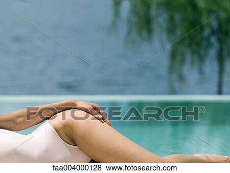 Woman lying on side near pool View Large Photo Image Stock Photo - Woman lying on side near pool. Fotosearch