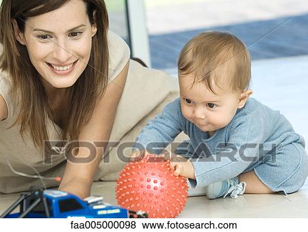 Stock Photo - Woman playing with baby . Fotosearch