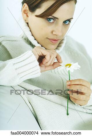 Woman plucking petal from flower View Large Photo Image Picture - Woman plucking petal from flower. Fotosearch