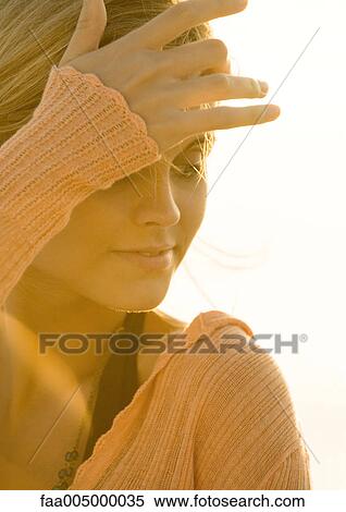 Woman pushing hair out of eyes View Large Photo Image Stock Photography - Woman pushing hair out of eyes. Fotosearch
