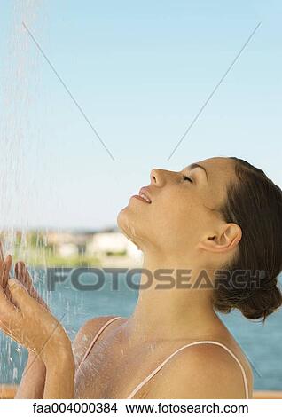 Woman showering off outside View Large Photo Image Picture - Woman showering off outside. Fotosearch