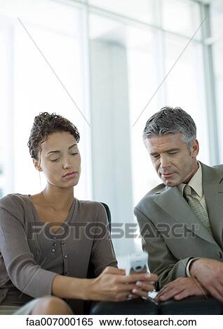 Woman showing man cell phone View Large Photo Image Stock Photography - Woman showing man cell phone. Fotosearch