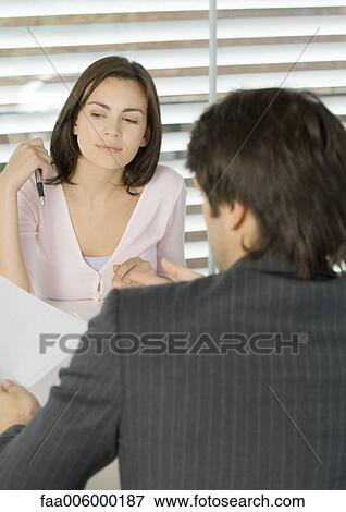 Woman sitting across from businessman View Large Photo Image Stock Photo - Woman sitting across from businessman. Fotosearch