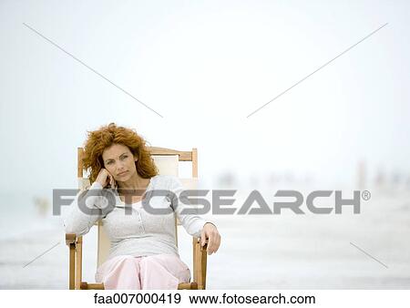 Woman sitting in beach chair View Large Photo Image Stock Photo - Woman sitting in beach chair. Fotosearch