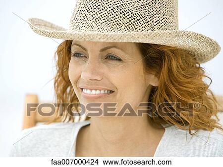 Woman sitting in beach chair, wearing sun hat View Large Photo Image Picture - Woman sitting in beach chair, wearing sun hat. Fotosearch