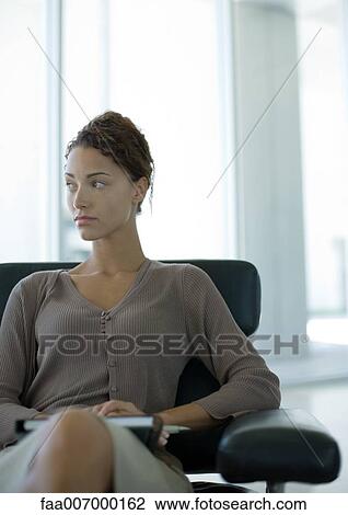 Woman sitting in office lobby View Large Photo Image Stock Image - Woman sitting in office lobby. Fotosearch