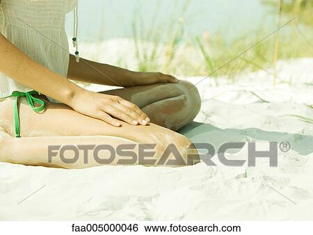 Woman sitting in sand, low section View Large Photo Image Stock Photograph - Woman sitting in sand, low section. Fotosearch