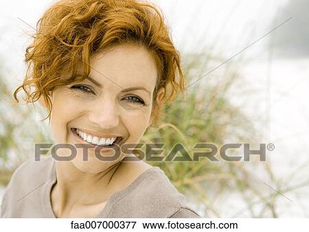 Stock Photo - Woman smiling at camera. Fotosearch