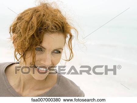 Woman smiling on beach View Large Photo Image Stock Image - Woman smiling on beach. Fotosearch