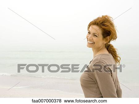 Woman smiling on beach View Large Photo Image Stock Photo - Woman smiling on beach. Fotosearch