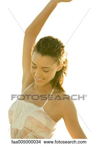 Woman smiling with arm up View Large Photo Image Picture - Woman smiling with arm up . Fotosearch