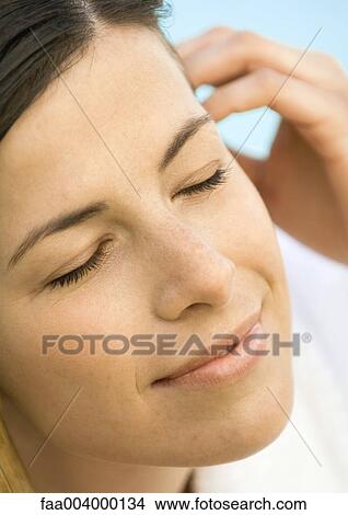 Woman smiling with eyes closed, close-up View Large Photo Image Picture - Woman smiling with eyes closed, close-up. Fotosearch
