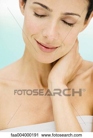 Woman smiling with hand on neck and eyes closed View Large Photo Image Stock Image - Woman smiling with hand on neck and eyes closed. Fotosearch