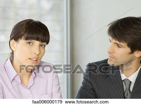 Woman speaking with businessman, looking at camera View Large Photo Image Stock Photo - Woman speaking with businessman, looking at camera. Fotosearch