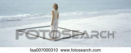 Woman standing inside square on beach View Large Photo Image Stock Image - Woman standing inside square on beach. Fotosearch