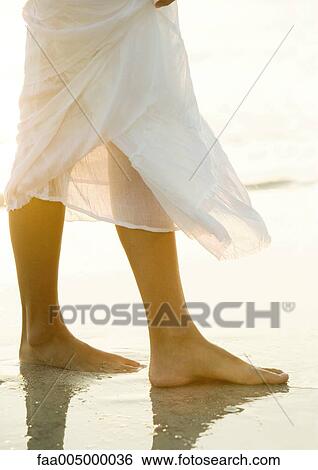 Woman standing on beach View Large Photo Image Stock Photograph - Woman standing on beach. Fotosearch